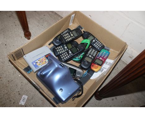 A box containing a Super Nintendo game, Street Fighter II, Turbo, a Polaroid camera and a quantity of Nokia mobile phones (un