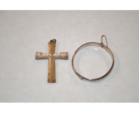 A silver snap bangle and a large silver crucifix pendant, approx. total weight 32.5gms 