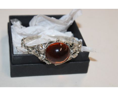 A Hallmarked vintage Sterling silver and amber bangle, (amber with insect inclusions)