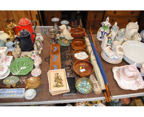 A quantity of various turned wooden bowls, two coat racks, a cast iron door stop, umbrellas, walking stick etc.