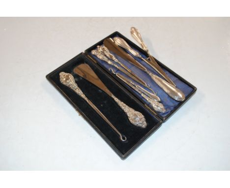 A cased silver handle shoe horn and button hook; another silver handled shoe horn; four button hooks and a pair of glove stre