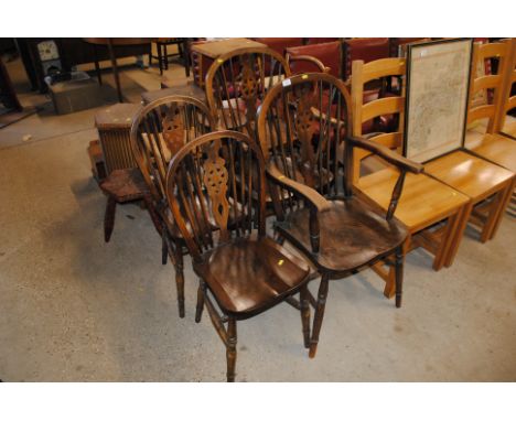 A set of four stick and wheelback dining chairs, two standards and two elbows