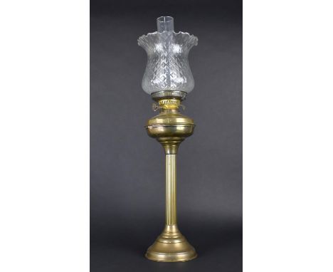 An Edwardian Brass Oil Lamp, Support in the Form of a Ribbed Column with Glass Shade and Chimney, Overall Height 71cms 