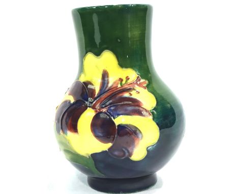 Moorcroft green ground vase in the Hibiscus pattern with Queen Mary sticker to base, H: 10 cm. No cracks, chips or visible re