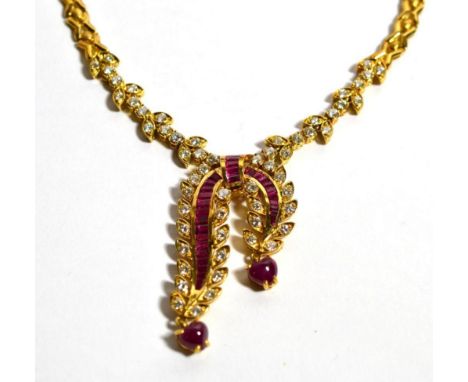 A ruby and diamond necklace, a scroll front with channel set calibré cut ruby ribbons, with diamond set leaves and two heart 
