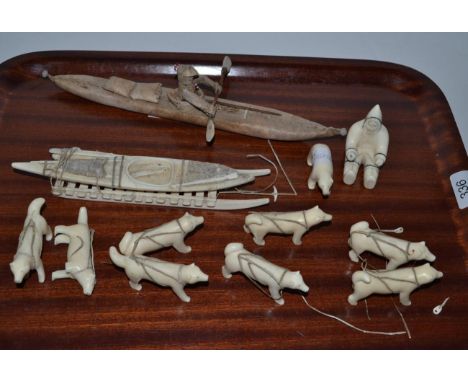 Inuit artifacts comprising marine ivory dog sled and kayak 