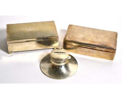 An engine turned silver cigarette box; another silver cigarette box; and a silver capstan inkwell