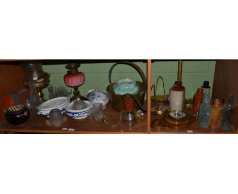 An oil lamp with pink moulded glass reservoir and chimney, a brass paraffin lamps, shade and chimney; a brass preserve pan; a