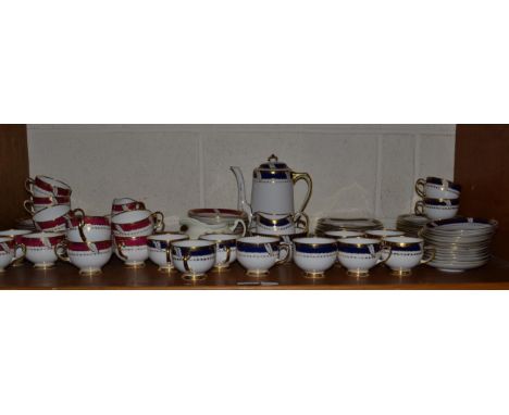 A Royal Albert Crown china tea service, 12 settings, with red and gilt boarders; another part service in the blue colourway a