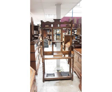 1930s oak hallstand with central bevelled mirror back, glove box and two stick trays below with spiral twist supports, 93cm w