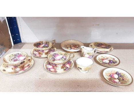 Three Aynsley Orchard Gold fruit pattern cups and four saucers together with milk jug and sugar bowl, footed dish and two sma