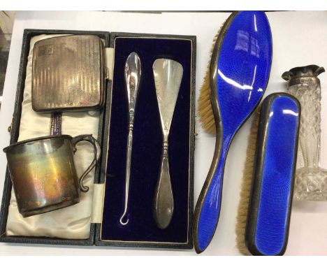 Two silver and blue enamel brushes, silver cigarette case, silver mug, silver topped glass vase and silver handled button hoo