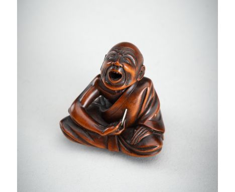 A WOOD NETSUKE OF A PROFESSIONAL SNEEZER, MEIJIJapan, Meiji period (1868-1912) Carved as a professional sneezer seated with h