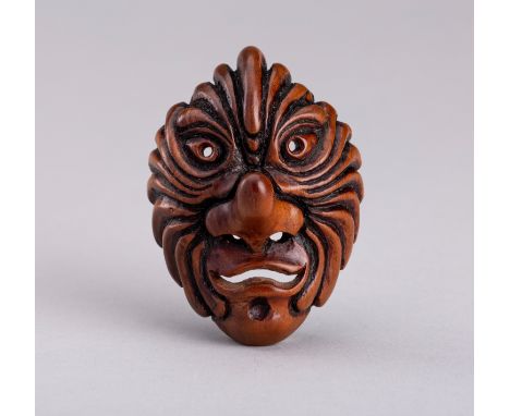 A BESHIMI WOOD MASK NETSUKEJapan, Meiji period (1868-1912)Boldly carved as a mask with a prominent long nose with pierced nos