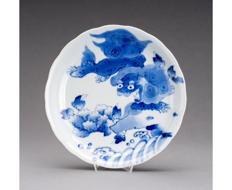 A BLUE AND WHITE IMARI PORCELAIN DISH 'SHISHI', EDOJapan, Edo Period (1615-1868), 19th century. Of lobed form, painted in und