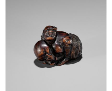 AN EDO SCHOOL WOOD NETSUKE OF ARIOMARU STRUGGLING WITH AN OCTOPUSSignedJapan, Edo (Tokyo), 19th century, Edo period (1615-186