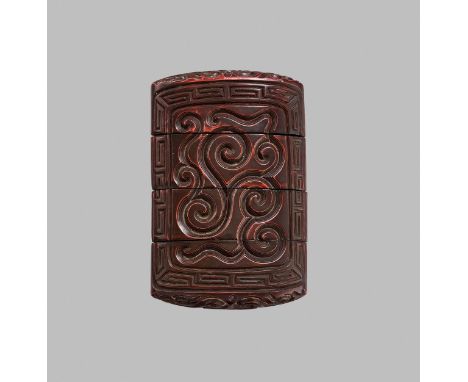 A GURI-LACQUER THREE-CASE INROUnsigned Japan, 18th century, Edo period (1615-1868)Well carved on either side with scroll desi