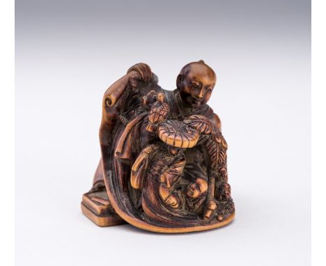SHOSAI: A WOOD NETSUKE WITH OTSU-E-FIGURESSigned Shosai 抄齋Japan, Meiji period (1868-1912)Carved as a seated man opening a scr