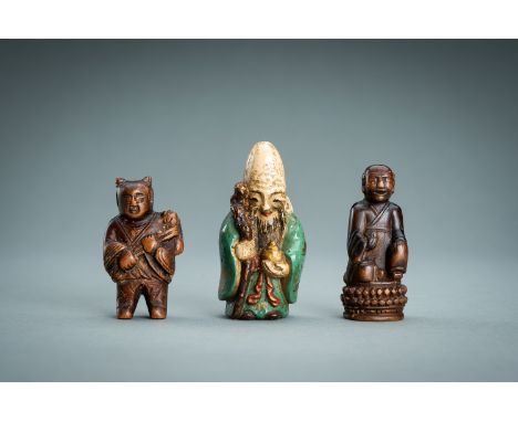 A LOT WITH THREE NETSUKE, 19th CENTURYJapan, 19th centuryThe first carved from wood as a karako (Chinese boy), standing and h