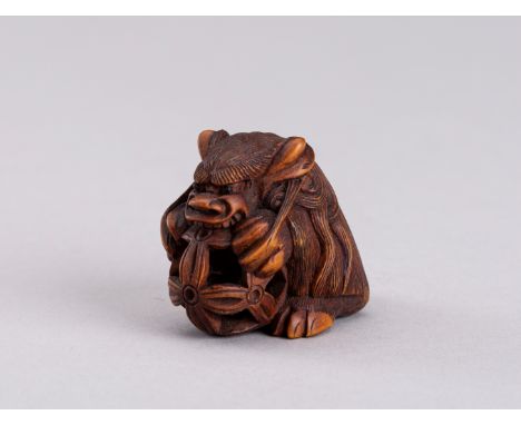 GIZAN: A BOXWOOD NETSUKE OF A SHISHI, 19th CENTURYBy Gizan, signed GizanJapan, 19th century The seated shishi lion carved fac
