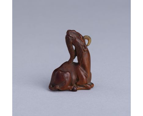 A WOOD NETSUKE OF A SINIU, MEIJIJapan, Meiji period (1868-1912) Boldly carved as a recumbent siniu with the legs drawn in and