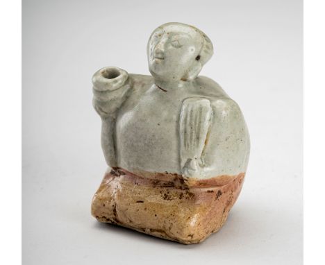 A GLAZED CERAMIC FIGURE, 19th CENTURYJapan, Edo period (1615-1868). The small figure molded seated and holding various object