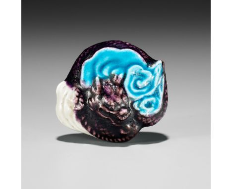 A RARE NANKI OTOKAYAMA GLAZED PORCELAIN NETSUKE OF A DRAGON AMONGST CLOUDSWith underglaze blue mark Nanki Otokayama 南紀男山Japan