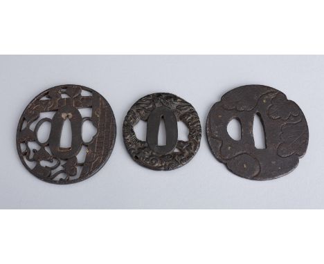 A GROUP OF THREE IRON TSUBA, EDOJapan, Edo period (1615-1868)  The first of tate-maru-gata (oval) form with two hitsu, cast i
