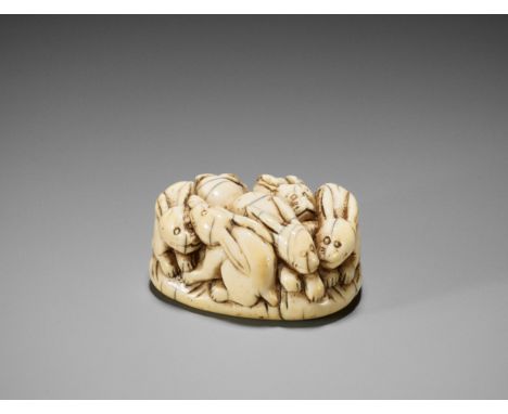 A RARE IVORY NETSUKE OF A PILE OF RABBITSJapan, 18th century, Edo period (1615-1868)Of appealingly compact form, carved as si