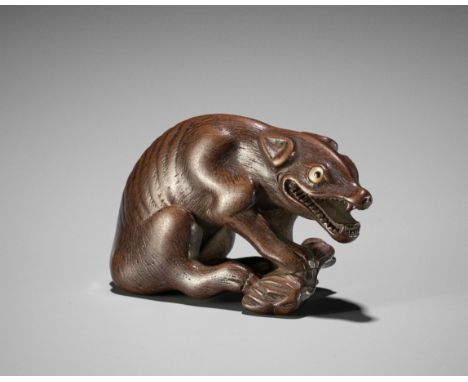 A FINE WOOD NETSUKE OF A WOLF WITH HAUNCH OF VENISONUnsignedJapan, probably Kyoto, late 18th to early 19th century, Edo perio