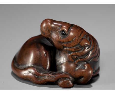 IKKAN: A SUPERB WOOD NETSUKE OF A RECUMBENT HORSEBy Ikkan, signed Ikkan 一貫Japan, Nagoya, early 19th century, Edo period (1615