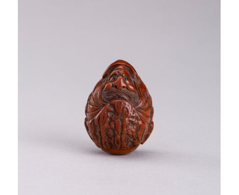 A SIGNED WALNUT NETSUKE OF DARUMA, MEIJIJapan, Meiji period (1868-1912)The kurumi netsuke finely carved as Daruma completely 