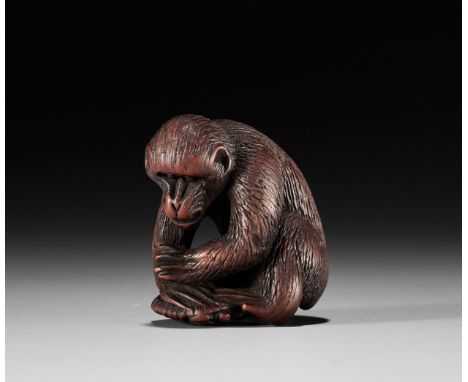A WOOD NETSUKE OF A MONKEY WITH A TORTOISE, 19th CENTURYJapan, 19th century Depicting a monkey with neatly incised fur, holdi
