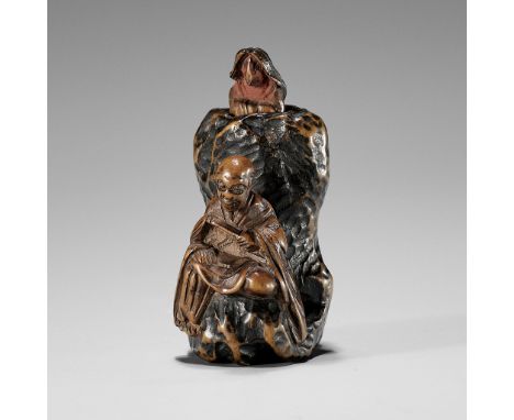 A RARE AND UNUSUAL TRICK WOOD NETSUKE OF A RAKAN AND FOX  UnsignedJapan, probably Edo (Tokyo), 19th century, Edo period (1615