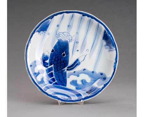 A BLUE AND WHITE ARITA PORCELAIN DISH 'LEAPING CARP', EDOJapan, Edo Period (1615-1868), 19th century. The dish with lightly l