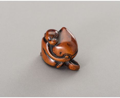 A BOXWOOD NETSUKE OF A MONKEY WITH PEACHJapan, Edo period (1615-1868)A humorous scene with a monkey holding an oversized peac