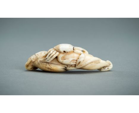AN IWAMI SCHOOL BOAR'S TOOTH NETSUKE OF A CRAB ON LOTUS LEAF, EDOJapan, Iwami province, late 18th to early 19th century, Edo 