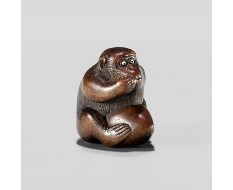 A WOOD NETSUKE OF A MONKEY EATING A PEACH, ATTRIBUTED TO MIWAAttributed to Miwa, unsignedJapan, Edo (Tokyo), late 18th centur