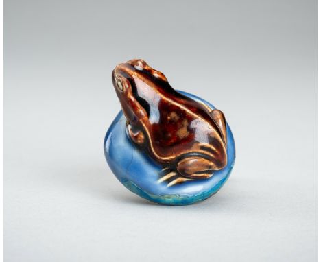 A HIRADO PORCELAIN NETSUKE OF A FROG ON A MUSHROOM, 19th CENTURYJapan, 19th centuryCrafted as a frog squatting on a mushroom,