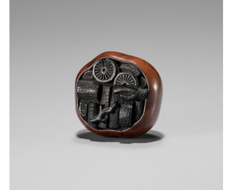 A BOXWOOD AND EBONY NETSUKE OF A BASKET OF CHARCOALUnsignedJapan, 18th century, Edo period (1615-1868)Carved as a shaped bask