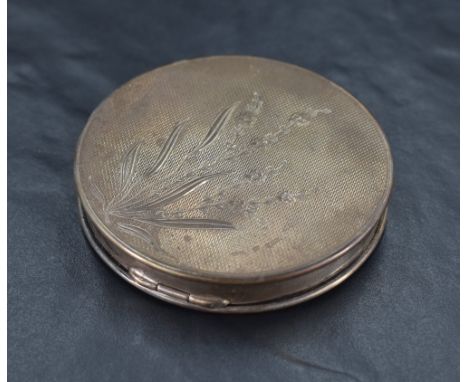 A Queen Elizabeth II silver powder compact2, of circular form with engine-turned decoration and engraved foliate spray, marks