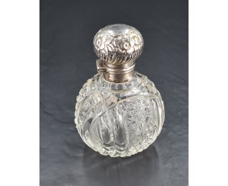 An Edwardian silver topped cut-glass scent bottle, of typical globular form cut with overlapping ovals and star cut panels, t