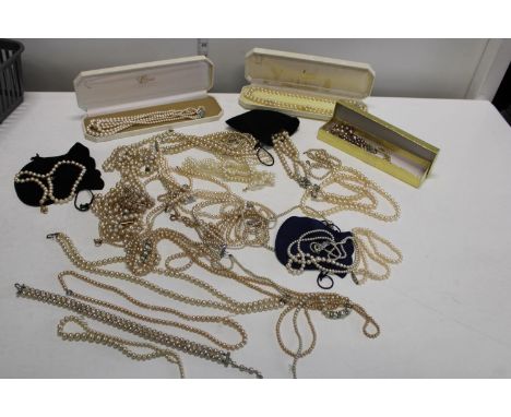 A job lot of simulated pearl necklaces 