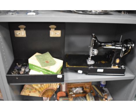 A 20th century portable electric sewing machine by Singer with case and box model no. 221K1