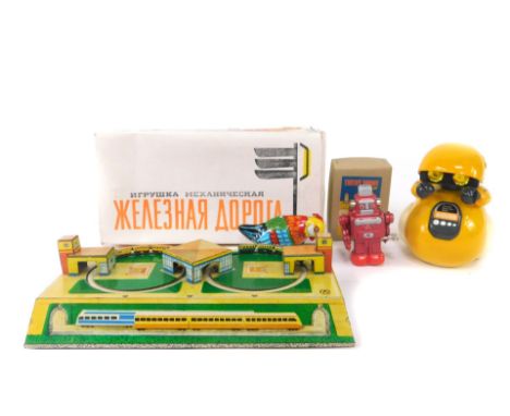 A Russian tinplate double loop train track, boxed, lacking key., a Japanese wind-up robot., a tinplate chicken., and a Should