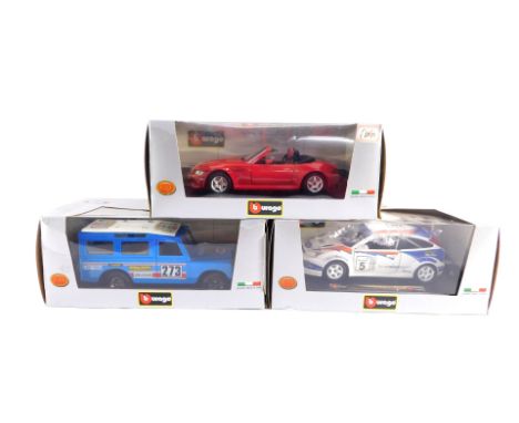 Three BB Burago Collection die cast cars, 1:24 scale, comprising a Ford Focus WRC., Land Rover Defender., and BMW Roadster, a