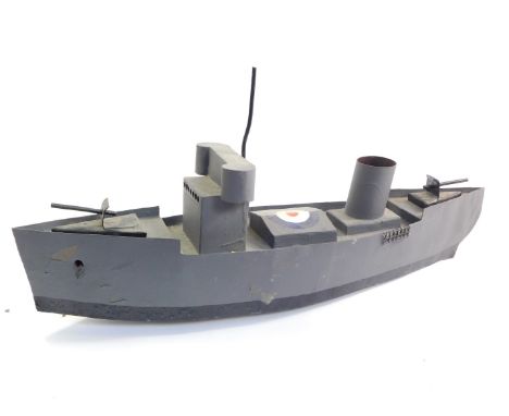 A scale model of a WWII British Naval gun boat, raised on rollers, 59cm wide.