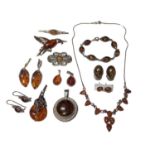 Group of amber jewellery in silver and white metal mounts