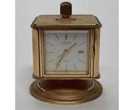 A Looping brass cased table clock, with thermometer, barometer, and hygrometer, the whole encased in a cube, raised on a rota