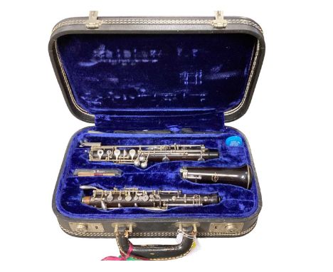 Good quality oboe in case stamped 'La Marque Paris', with songbooks